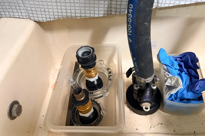 Slide: The Image of Plumbing components and gloves in an American Tug 34, 2002 model boat. - 61