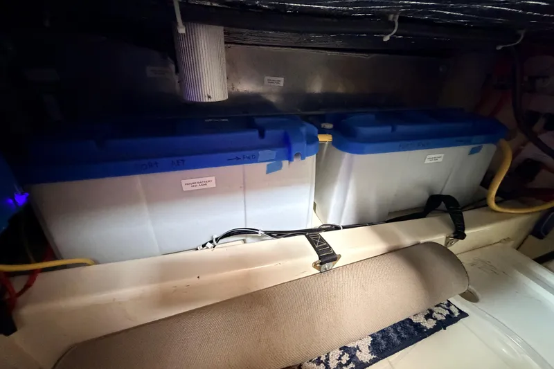 Slide: The Image of Battery compartment of a 2002 American Tug 34, featuring labeled storage containers. - 64