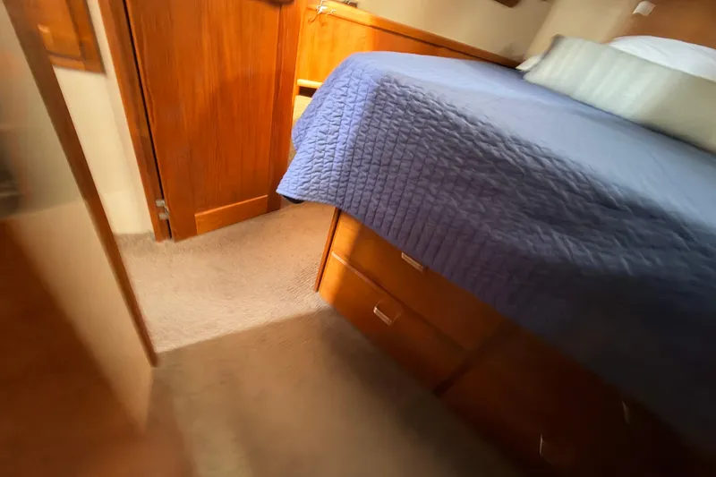 Slide: The Image of Cozy cabin interior of 2002 American Tug 34 with blue bedding and wooden furnishings. - 72