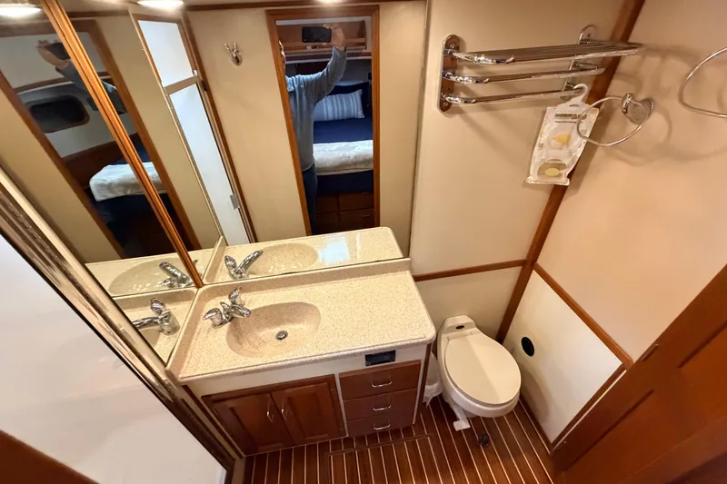 Slide: The Image of Bathroom interior of 2002 American Tug 34 with sink, mirror, and toilet. - 78