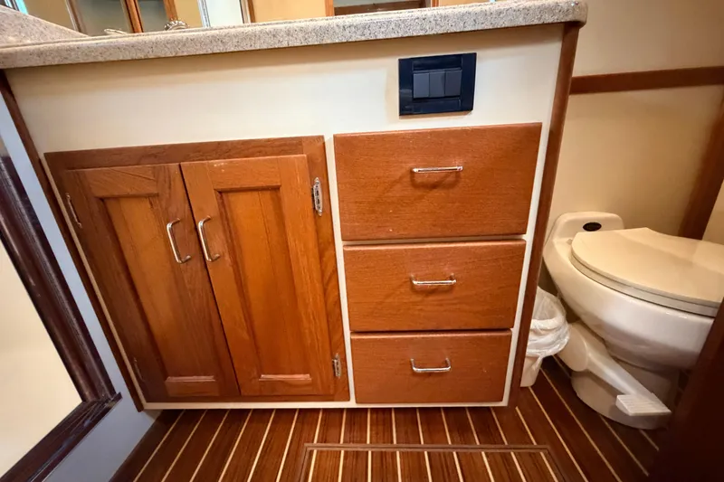 Slide: The Image of Bathroom interior of 2002 American Tug 34 with wooden cabinets and toilet. - 79