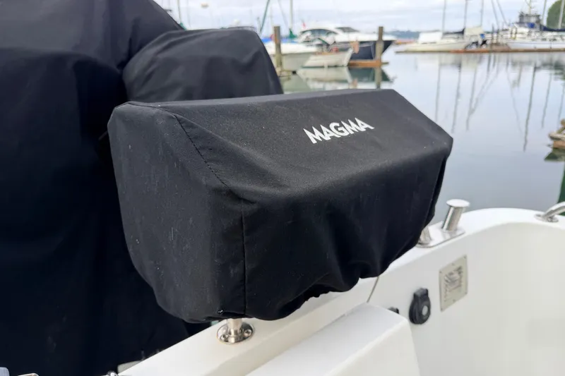 Slide: The Image of Covered Magma grill on 2002 American Tug 34 boat at marina. - 83