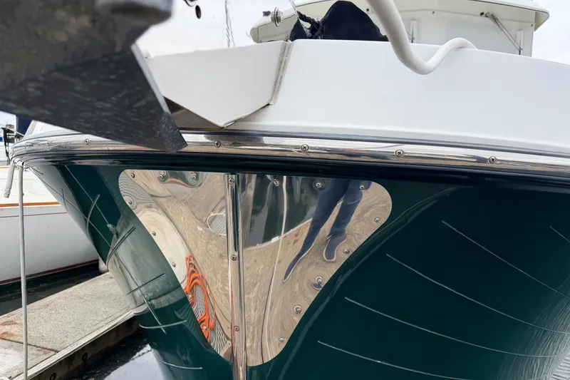 Slide: The Image of Close-up of a 2002 American Tug 34 boat's polished hull and anchor detail. - 86