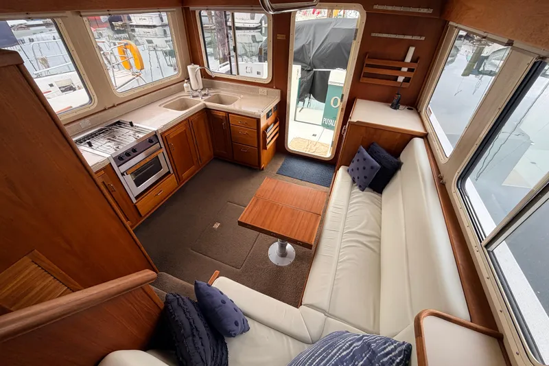 Slide: The Image of Interior of 2002 American Tug 34 with kitchen and seating area. - 9