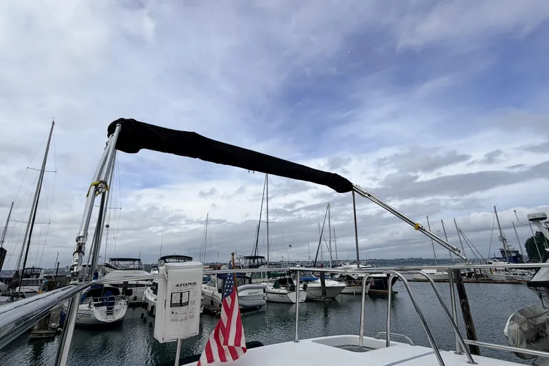 Slide: The Image of American Tug 34 (2002) docked in a marina with cloudy skies and boats. - 91