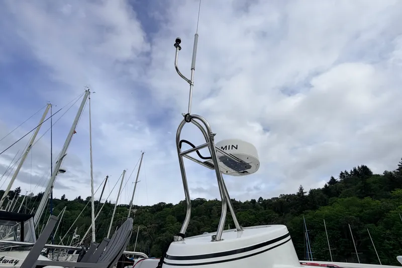 Slide: The Image of Radar equipment on a 2002 American Tug 34 boat against a cloudy sky. - 94