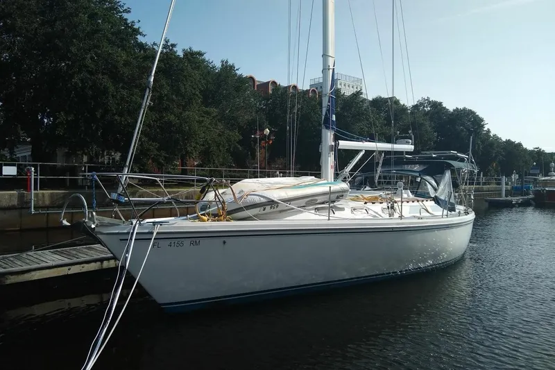 The Image of Sailboat Catalina 42, 1991 model, docked at marina with trees in background. - 1