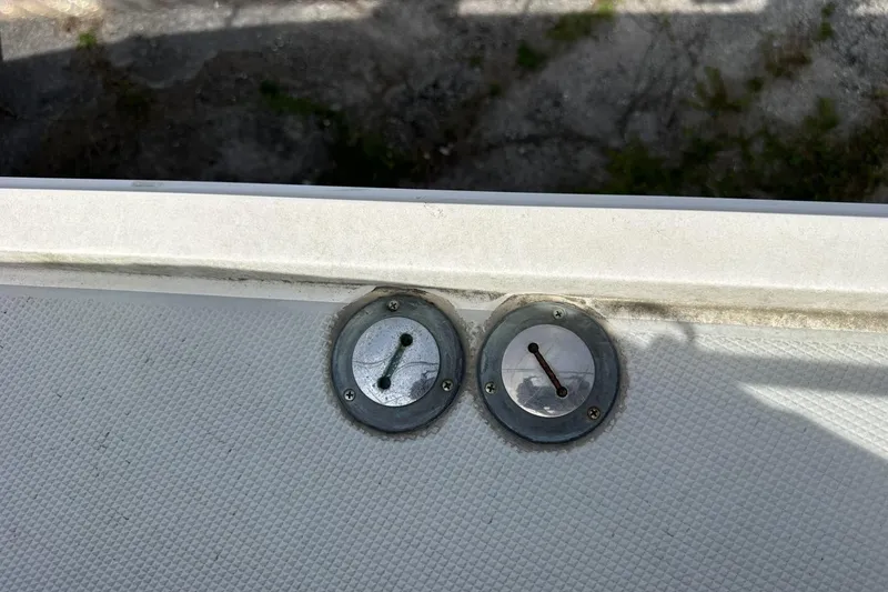 Slide: The Image of Deck fittings on a 1991 Catalina 42 sailboat, featuring two metal caps. - 100