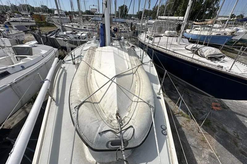 Slide: The Image of Sailboat deck with dinghy, Catalina 42, 1991 model, in a marina setting. - 101