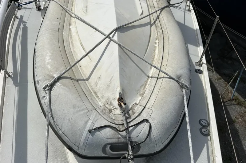 Slide: The Image of Inflatable dinghy secured on 1991 Catalina 42 sailboat deck. - 102
