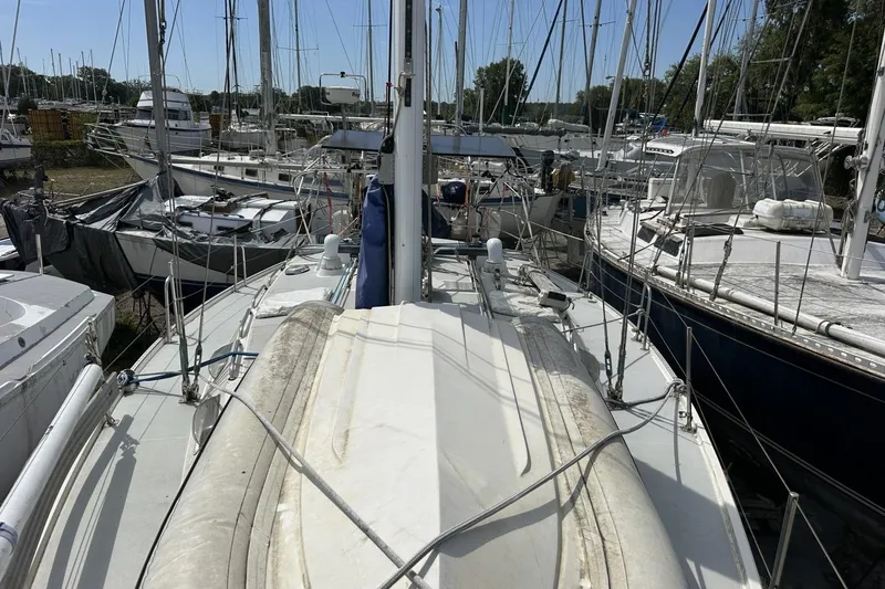 Slide: The Image of Sailboats docked at marina, featuring a 1991 Catalina 42 model. - 103