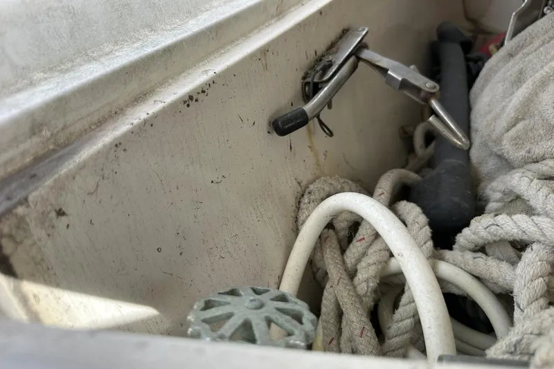 Slide: The Image of Storage compartment on a 1991 Catalina 42 sailboat with ropes and tools. - 106