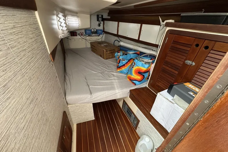 Slide: The Image of Interior cabin of a 1991 Catalina 42 sailboat with storage and bedding. - 11