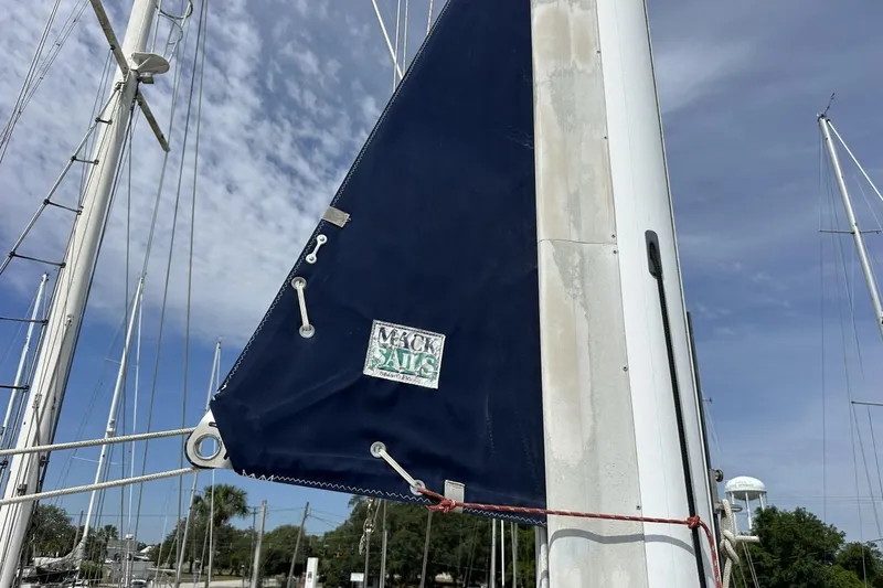 Slide: The Image of Sailboat mast with Mack Sails cover, Catalina 42, 1991 model, under blue sky. - 113