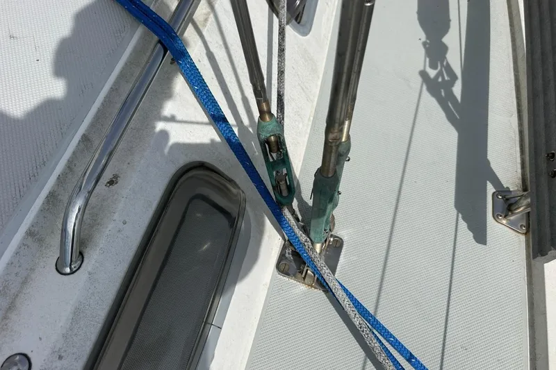 Slide: The Image of Close-up of Catalina 42 sailboat deck rigging, featuring blue and gray ropes, 1991 model. - 115
