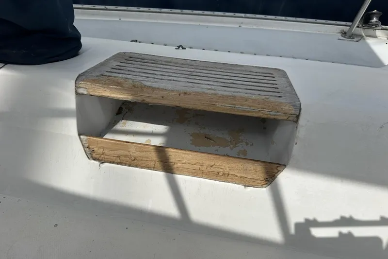 Slide: The Image of Wooden step on 1991 Catalina 42 sailboat deck, showing wear and sunlight. - 119