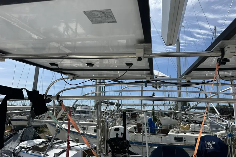 Slide: The Image of Solar panels on a 1991 Catalina 42 sailboat, docked in a marina. - 121