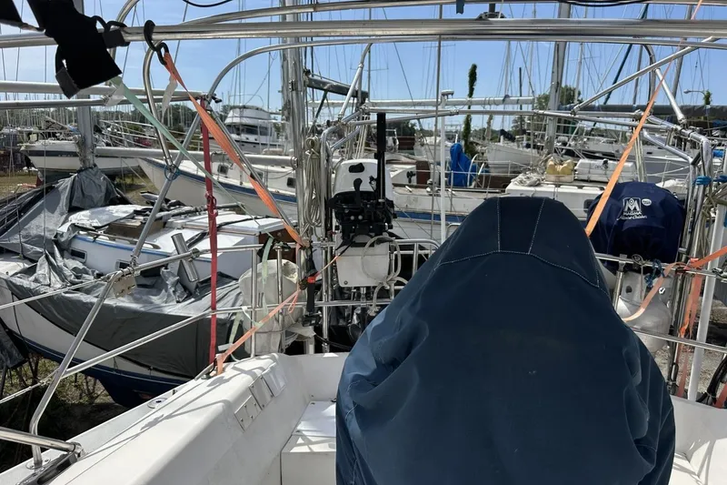 Slide: The Image of Sailboats docked at a marina, featuring a 1991 Catalina 42 model. - 124
