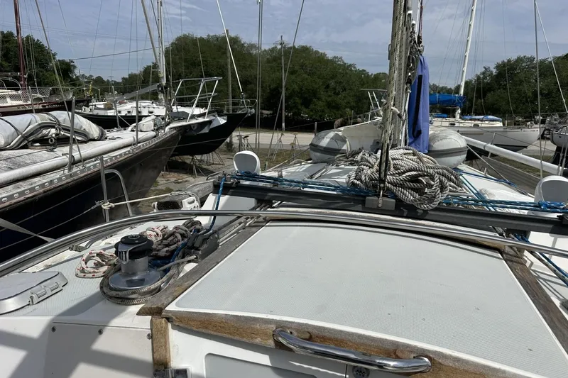 Slide: The Image of Sailboat deck view of a 1991 Catalina 42, docked with other boats nearby. - 125
