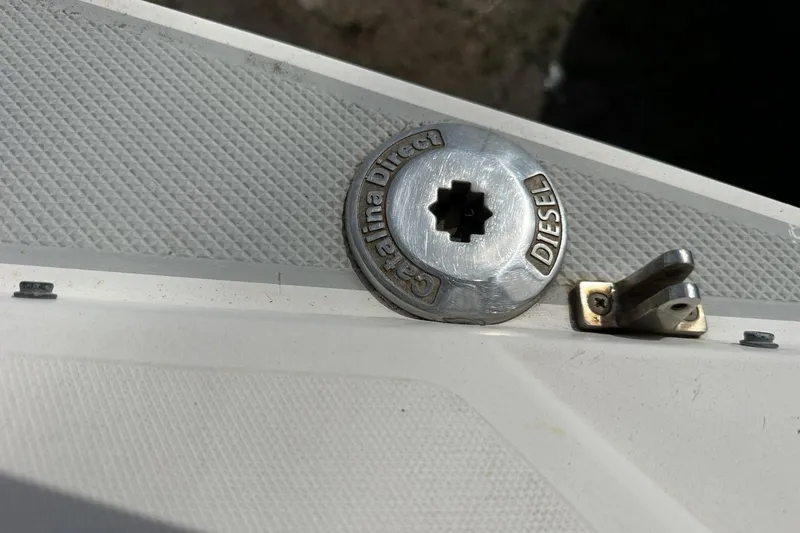 Slide: The Image of Catalina 42 diesel fuel cap on a 1991 model boat deck. - 129