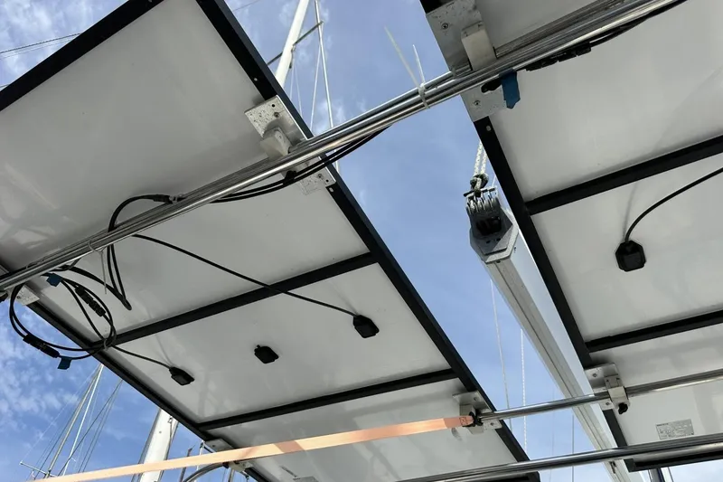 Slide: The Image of Solar panels and rigging on a 1991 Catalina 42 sailboat under a clear sky. - 133