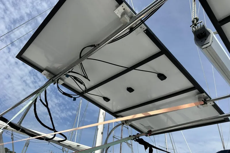 Slide: The Image of Solar panels installed on a 1991 Catalina 42 sailboat under a clear blue sky. - 134
