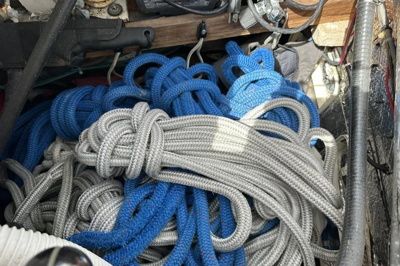 Slide: The Image of Coiled blue and gray ropes on a 1991 Catalina 42 sailboat. - 136
