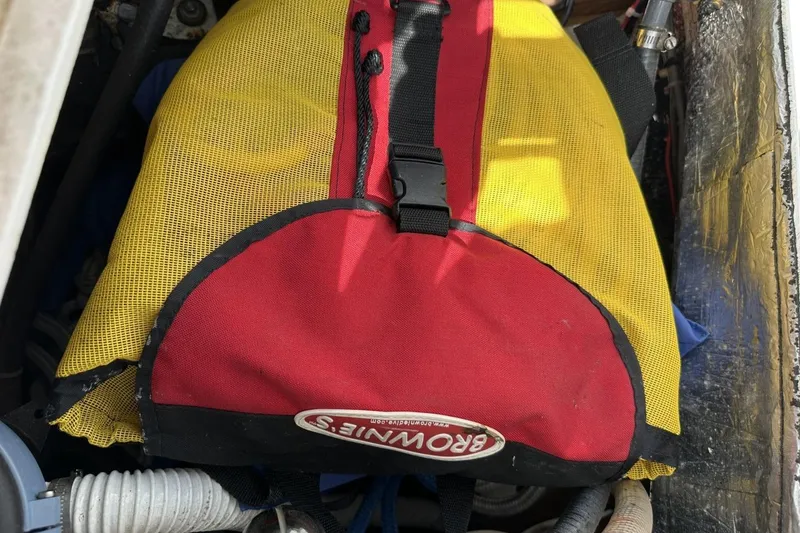 Slide: The Image of Yellow and red Browning bag in a 1991 Catalina 42 sailboat compartment. - 137