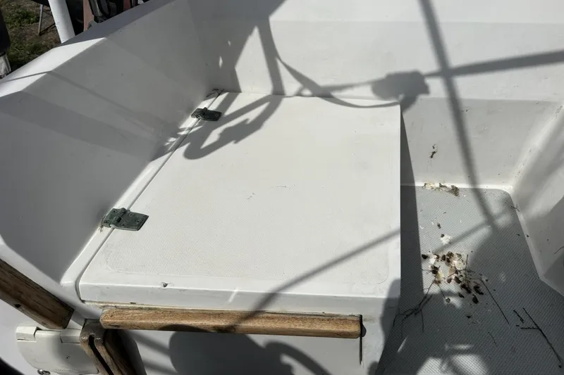 Slide: The Image of Cockpit area of a 1991 Catalina 42 sailboat with hinged storage compartment. - 139