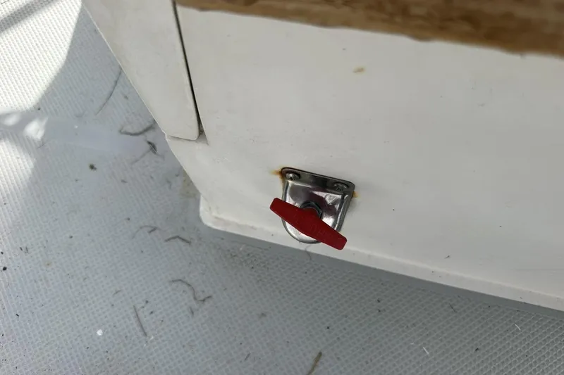 Slide: The Image of Red lever on a 1991 Catalina 42 boat interior, mounted on white surface. - 140