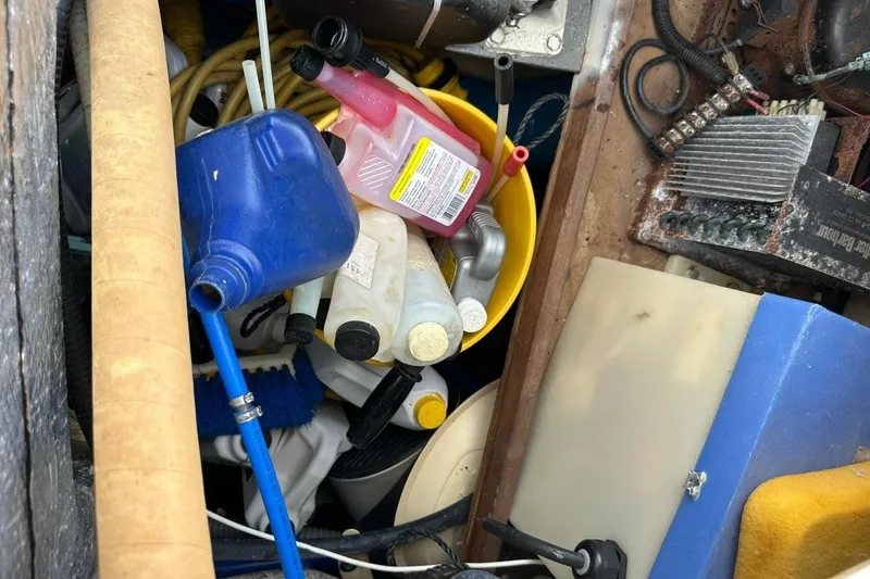 Slide: The Image of Assorted maintenance supplies in a Catalina 42 sailboat storage compartment, 1991 model. - 141