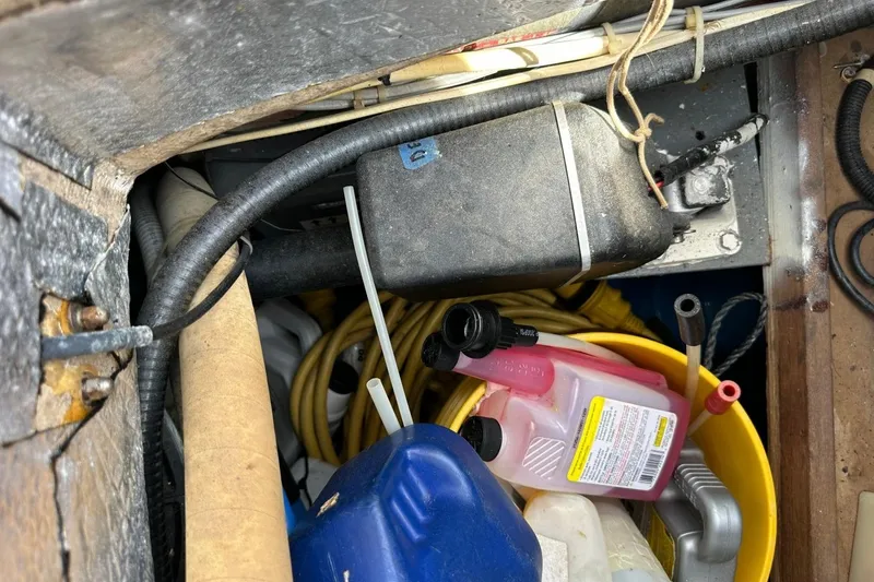 Slide: The Image of Storage compartment of a 1991 Catalina 42 sailboat with various maintenance supplies. - 142