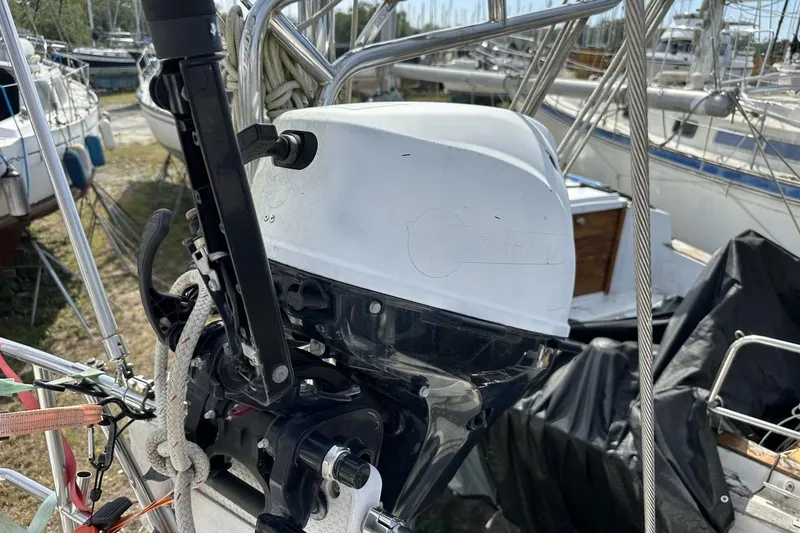 Slide: The Image of Outboard motor on a 1991 Catalina 42 sailboat, docked among other boats. - 157