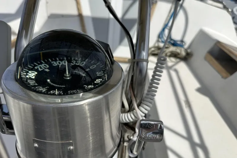 Slide: The Image of Compass and throttle controls on a 1991 Catalina 42 sailboat. - 164