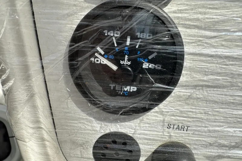 Slide: The Image of Temperature gauge on a 1991 Catalina 42 boat dashboard, wrapped in protective plastic. - 169