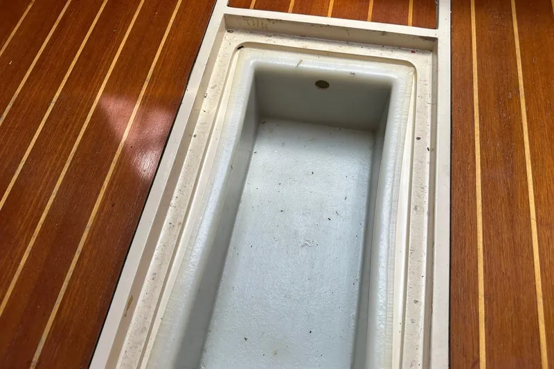 Slide: The Image of Wooden deck with built-in storage compartment on a 1991 Catalina 42 sailboat. - 17