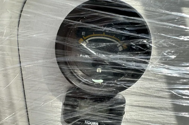 Slide: The Image of Fuel gauge and hour meter on a 1991 Catalina 42, wrapped in protective plastic. - 170
