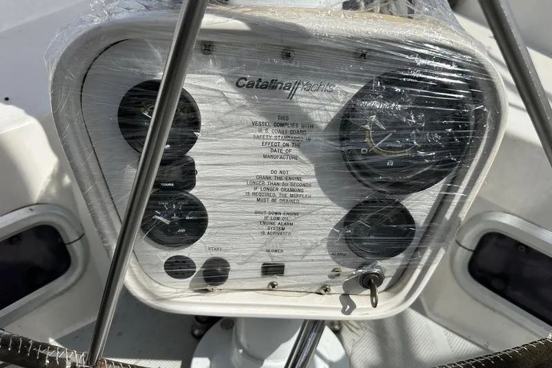 Slide: The Image of Control panel of a 1991 Catalina 42 yacht, wrapped in protective plastic. - 173