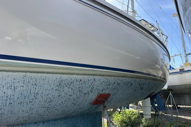 Slide: The Image of Catalina 42 sailboat from 1991 on dry dock, showing hull and keel. - 177