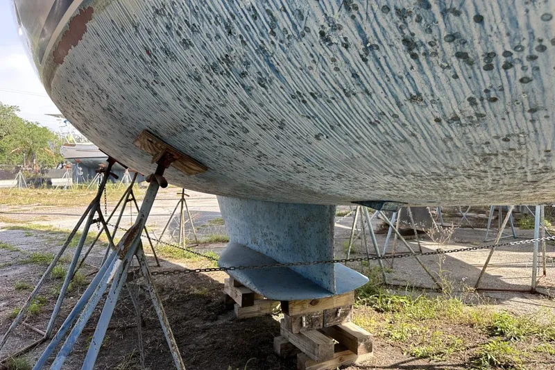 Slide: The Image of Bottom view of a 1991 Catalina 42 sailboat on stands, showing keel and hull condition. - 179