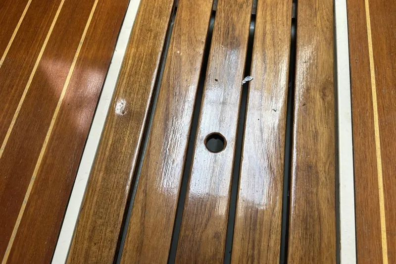 Slide: The Image of Polished wooden deck of a 1991 Catalina 42 sailboat with a central hole. - 18