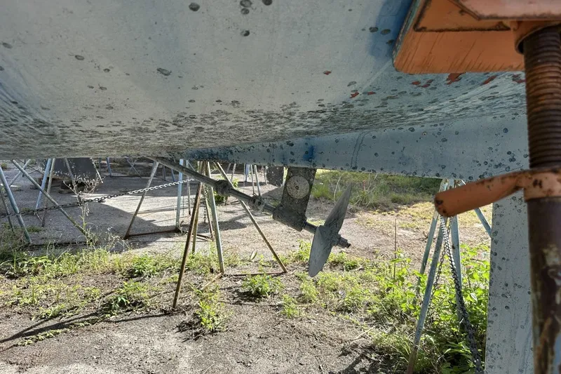 Slide: The Image of Bottom view of a 1991 Catalina 42 sailboat on stands, showing propeller and hull. - 180