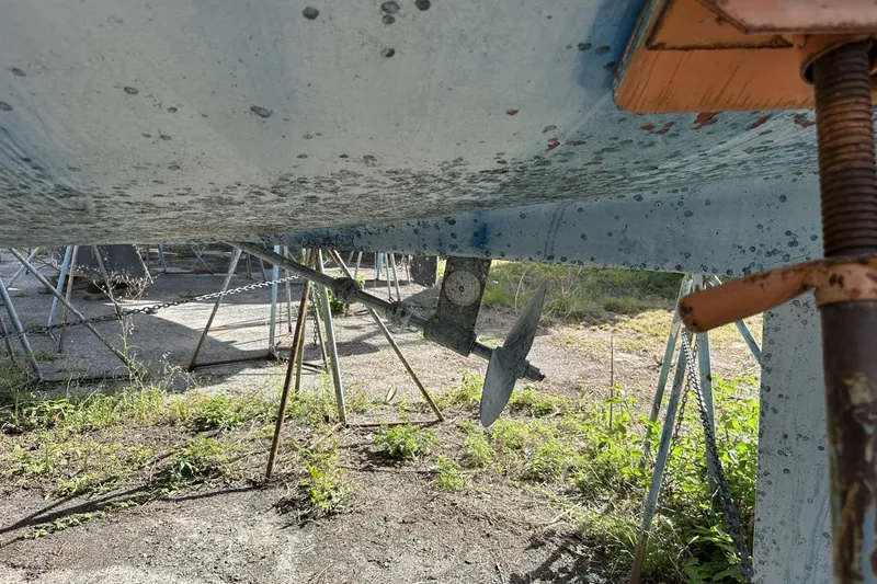 Slide: The Image of Bottom view of a 1991 Catalina 42 sailboat on stands, showing propeller and hull. - 181