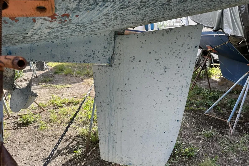 Slide: The Image of Close-up of a 1991 Catalina 42 sailboat keel with visible wear and marine growth. - 182