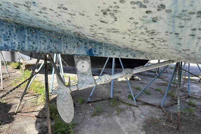 Slide: The Image of Underside of a 1991 Catalina 42 sailboat with visible propeller and supports. - 188