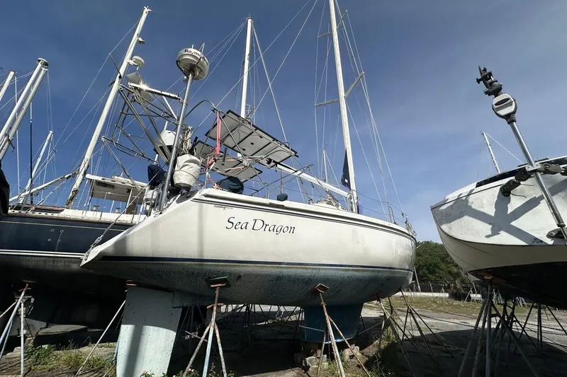 Slide: The Image of 1991 Catalina 42 sailboat "Sea Dragon" on stands, clear sky background. - 189