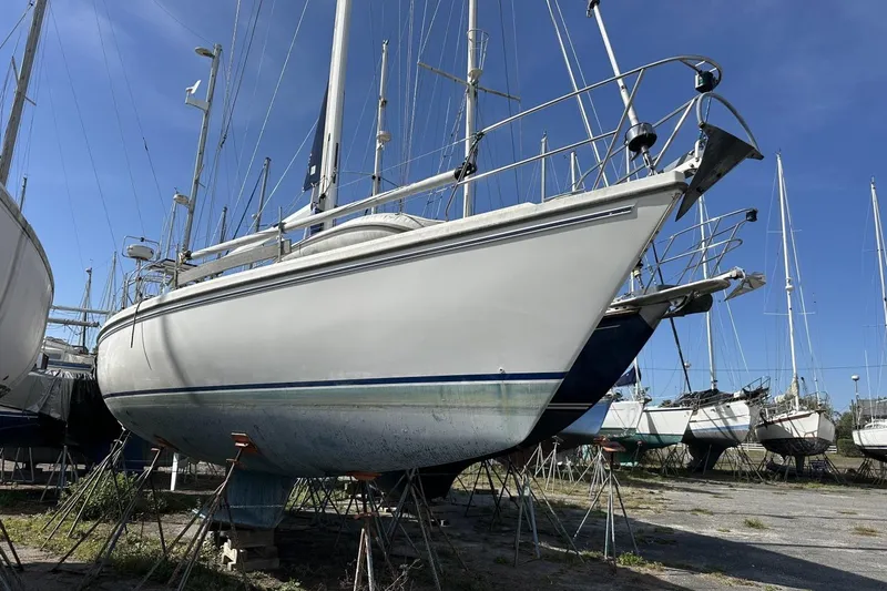 Slide: The Image of Sailboat on land, 1991 Catalina 42 model, in a boatyard under clear blue sky. - 194