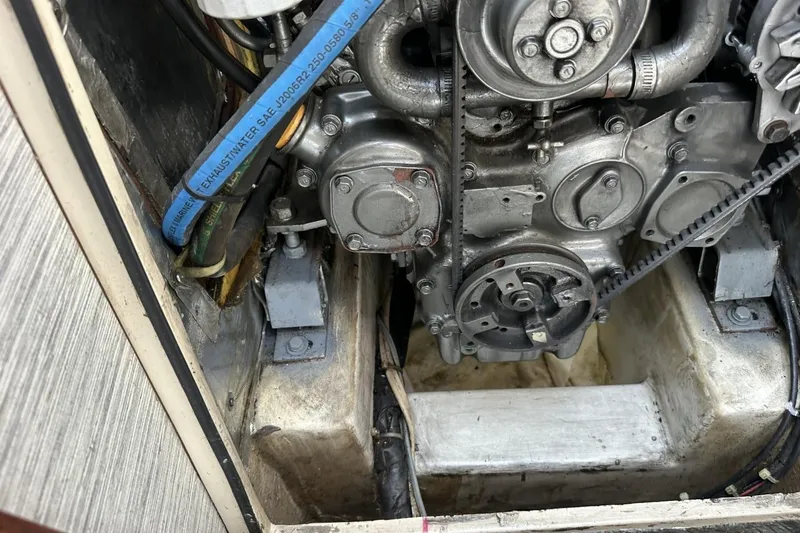 Slide: The Image of Engine compartment of a 1991 Catalina 42 sailboat, showing mechanical components and hoses. - 20