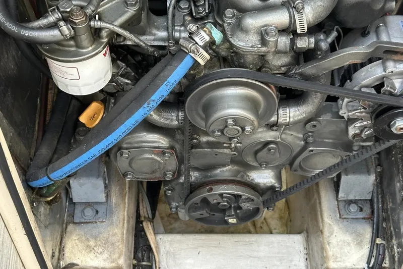 Slide: The Image of Engine compartment of a 1991 Catalina 42 sailboat, showing belts and components. - 22