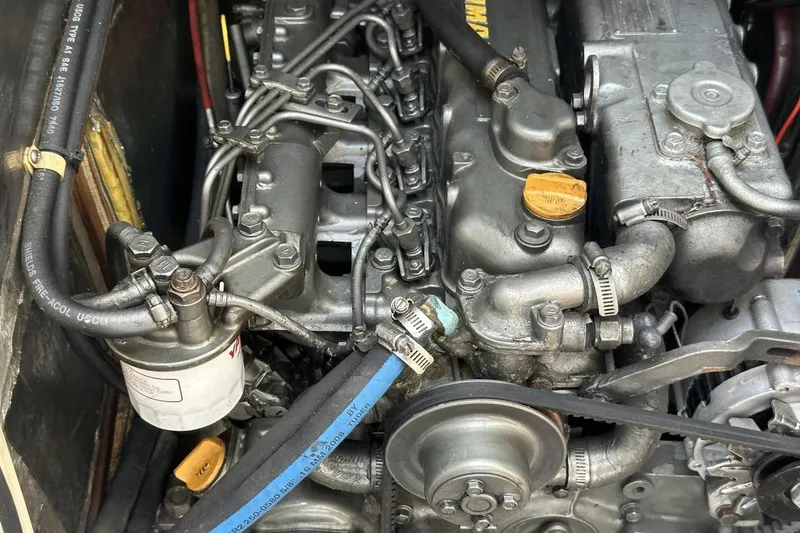 Slide: The Image of Engine compartment of a 1991 Catalina 42 sailboat, showcasing detailed mechanical components. - 23